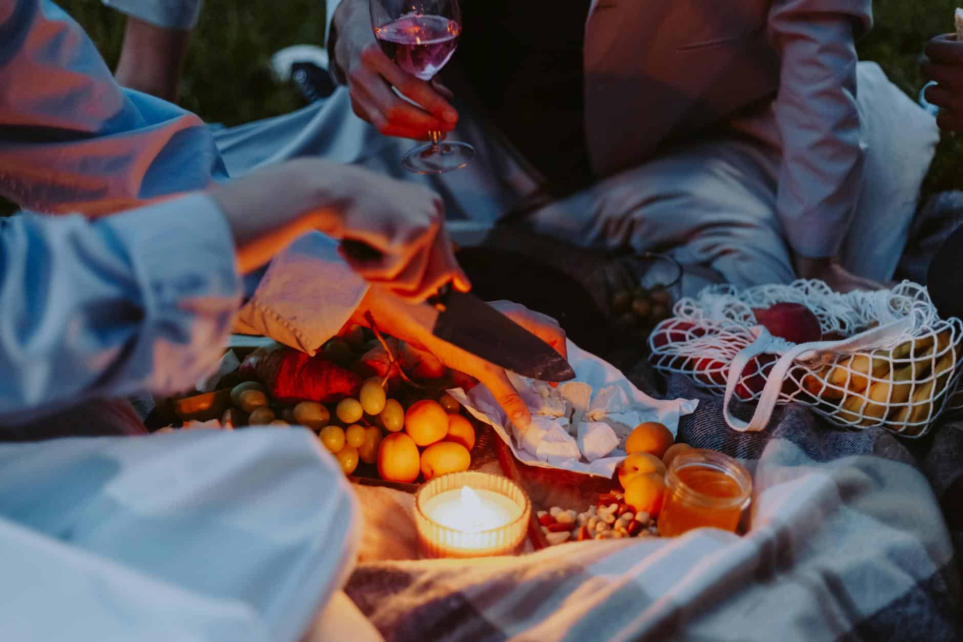 couple sitting on picnic blanket
